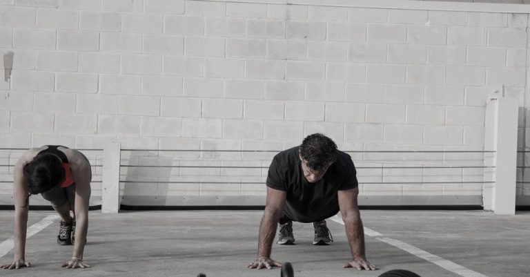 Brice Remaley coaching a client through a wall plank session
